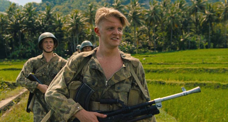 The East AKA De Oost 2020 Movie Scene Jonas Smulders as Mattias Cohen holding a Bren Mk1 heavy machinegun while on patrol in Indonesia