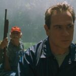 US Marshals 1998 Movie Scene Tommy Lee Jones as Samuel Gerard in a boar looking for Sheridan in the swamp
