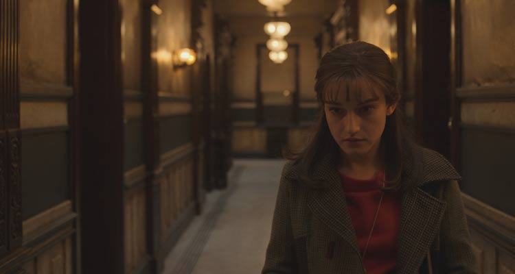 Apartment 7A 2024 Movie Scene Julia Garner as Terry Gionoffrio in the hallway of her building hearing strange noises