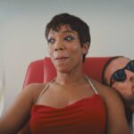 Blink Twice 2024 Movie Scene Naomi Ackie as Frida in an airplane on her way to an exotic island with Channing Tatum as Slater next to her