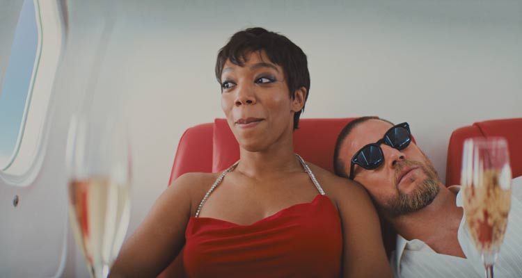 Blink Twice 2024 Movie Scene Naomi Ackie as Frida in an airplane on her way to an exotic island with Channing Tatum as Slater next to her