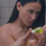 The Substance 2024 Movie Scene Demi Moore as Elisabeth preparing the inject the drug in her bathroom