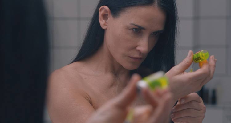 The Substance 2024 Movie Scene Demi Moore as Elisabeth preparing the inject the drug in her bathroom