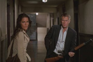 The Getaway 1972 Movie Scene Steve McQueen as Doc McCoy loading his shotgun during the finale in the hotel with Ali MacGraw as Carol right next to him