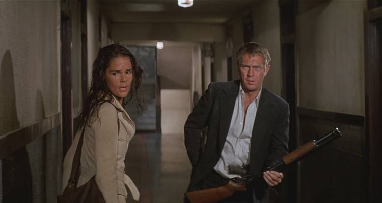 The Getaway 1972 Movie Scene Steve McQueen as Doc McCoy loading his shotgun during the finale in the hotel with Ali MacGraw as Carol right next to him