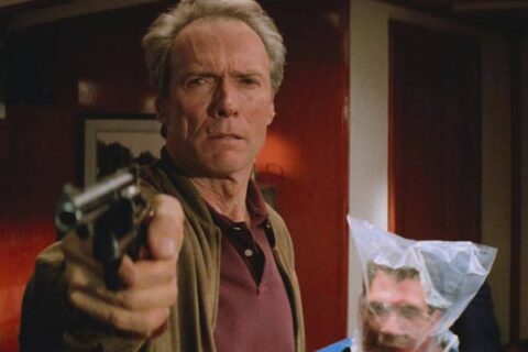 In The Line Of Fire 1993 Movie Scene Clint Eastwood as Frank Horrigan holding a gun while Dylan McDermott as Al D'Andrea is struggling to breathe behind him