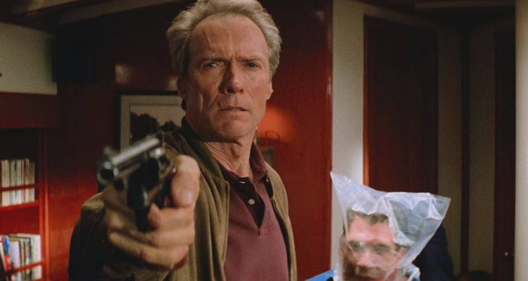 In The Line Of Fire 1993 Movie Scene Clint Eastwood as Frank Horrigan holding a gun while Dylan McDermott as Al D'Andrea is struggling to breathe behind him