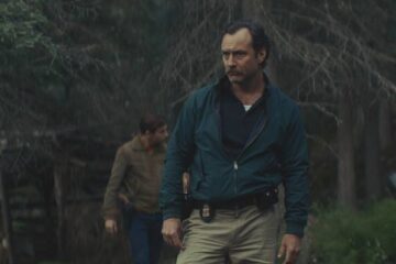 The Order 2024 Movie Scene Jude Law as Terry Husk looking for a white supremacist gang murder site in the woods