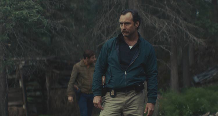 The Order 2024 Movie Scene Jude Law as Terry Husk looking for a white supremacist gang murder site in the woods