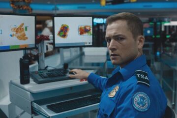 Carry On 2024 Movie Scene Taron Egerton as Ethan Kopek, a TSA agent working at an airport realizing he has to let a bomb through his scanner onto a flight