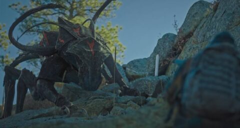 Elevation 2024 Movie Scene The Reaper monster hunting Anthony Mackie as Will on top of the mountain