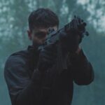 Running With Tigers AKA Tigres Et Hyenes 2024 Movie Scene Waël Sersoub as Malik practicing shooting in the woods before the heist
