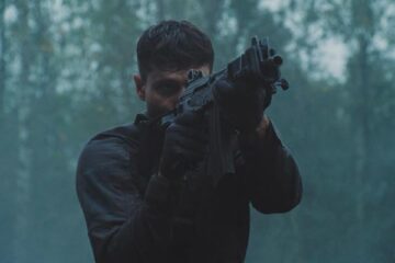 Running With Tigers AKA Tigres Et Hyenes 2024 Movie Scene Waël Sersoub as Malik practicing shooting in the woods before the heist