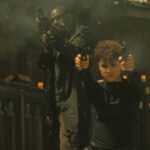 The Killer 2024 Movie Scene Nathalie Emmanuel as Zee and Omar Sy as Sey shooting at the bad guys inside the church