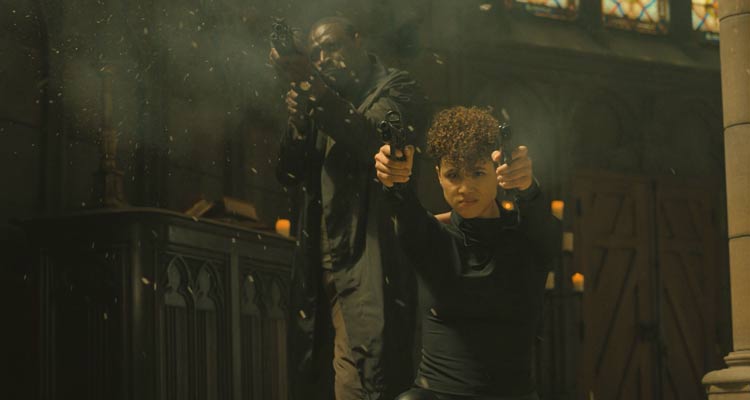 The Killer 2024 Movie Scene Nathalie Emmanuel as Zee and Omar Sy as Sey shooting at the bad guys inside the church