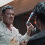 Weekend in Taipei 2024 Movie Scene Luke Evans as Agent John Lawlor holding a blowtorch during a fight in the kitchen