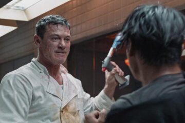 Weekend in Taipei 2024 Movie Scene Luke Evans as Agent John Lawlor holding a blowtorch during a fight in the kitchen