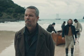 The Convert 2023 Movie Scene Guy Pearce as Thomas Munro arriving at the shores of New Zealand