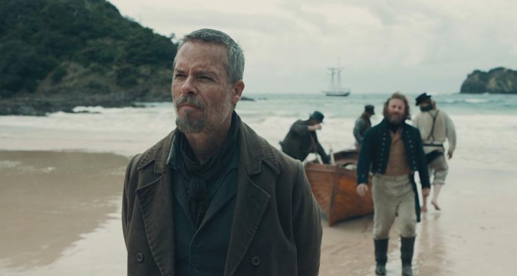 The Convert 2023 Movie Scene Guy Pearce as Thomas Munro arriving at the shores of New Zealand