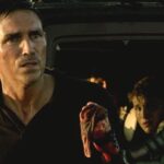 Transit 2012 Movie Scene Jim Caviezel as Nate with a bloody hand in front of a car with his family in it