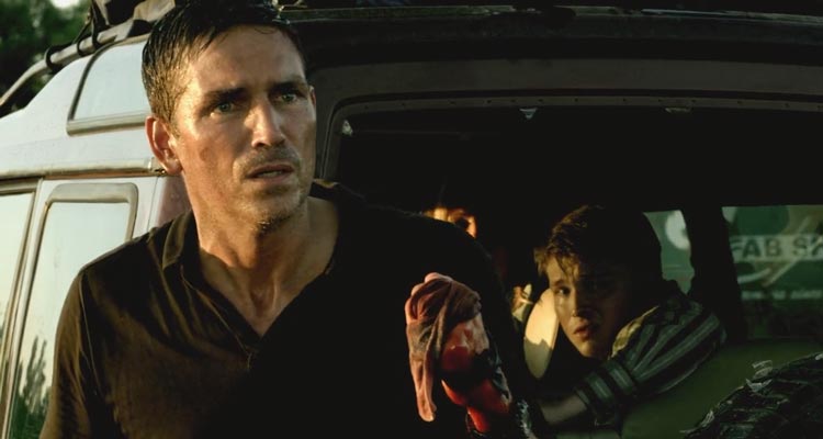 Transit 2012 Movie Scene Jim Caviezel as Nate with a bloody hand in front of a car with his family in it