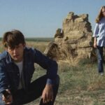 Badlands 1973 Movie Scene Martin Sheen as Kit holding a gun with Sissy Spacek as Holly standing behind him