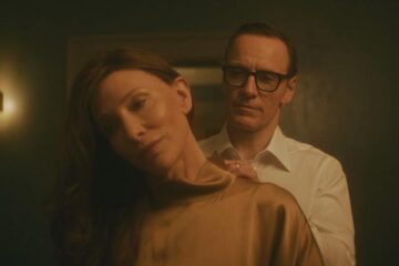 Black Bag 2025 Movie Scene Michael Fassbender as George Woodhouse helping Cate Blanchett as Kathryn St. Jean to put on a dress