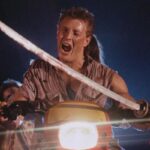 Demons 1985 Movie Scene Urbano Barberini as George driving a motorcycle through the theater while holding a sword
