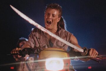 Demons 1985 Movie Scene Urbano Barberini as George driving a motorcycle through the theater while holding a sword