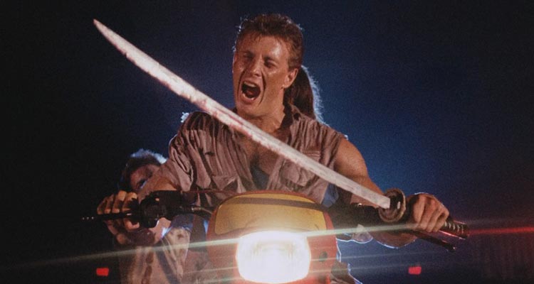 Demons 1985 Movie Scene Urbano Barberini as George driving a motorcycle through the theater while holding a sword