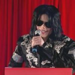 Michael Jackson An American Tragedy 2026 Scene 27 Michael Jackson addressing the public during a publicity event for his final tour