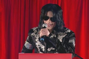 Michael Jackson An American Tragedy 2026 Scene 27 Michael Jackson addressing the public during a publicity event for his final tour