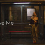 Believe Me 2026 Series Scene Miriam Petche as Carrie waiting for a black cab at the bus stop late at night