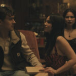 Obsession 2025 Movie Scene Inde Navarrette as Nikki sitting next to Michael Johnston as Bear jealous of Megan Lawless as Sarah