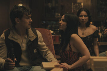 Obsession 2025 Movie Scene Inde Navarrette as Nikki sitting next to Michael Johnston as Bear jealous of Megan Lawless as Sarah